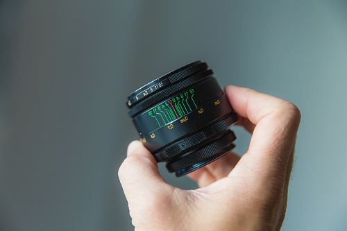 person holding black camera lens